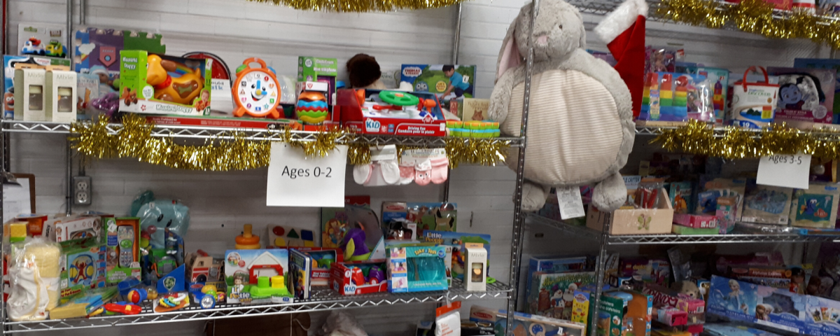 Warehouse gift room with shelves filled with colourful toys for young children.