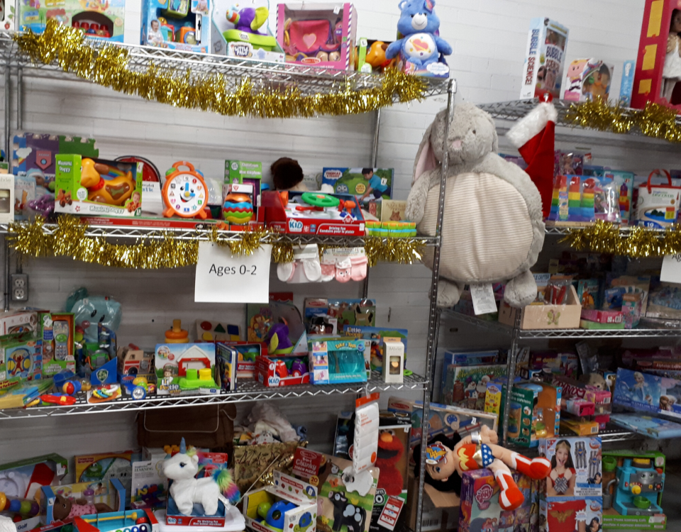 Warehouse gift room with shelves filled with colourful toys for young children.