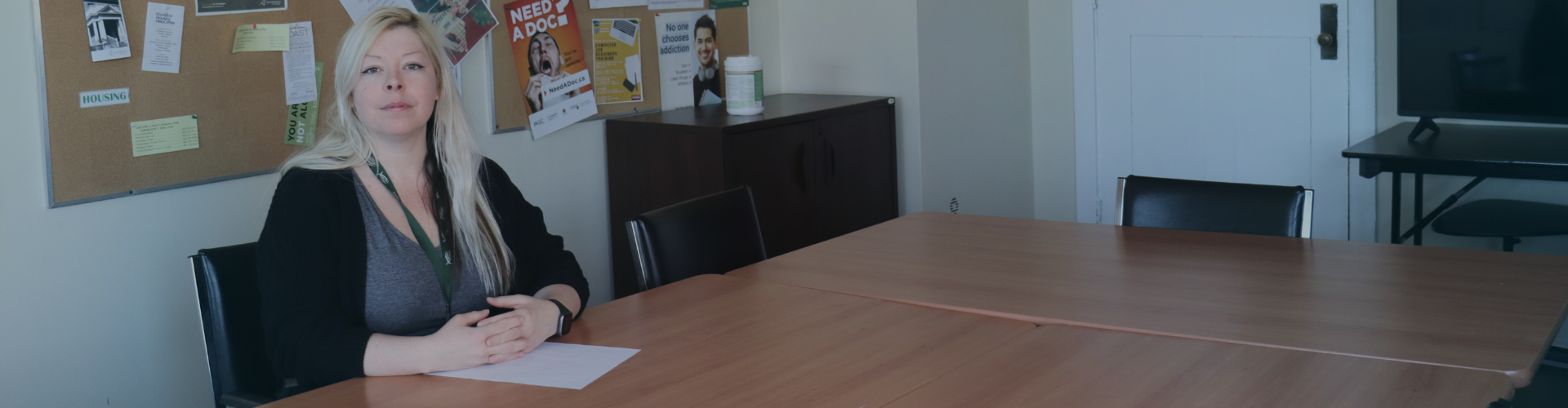 A woman sitting at a table ready for a meeting